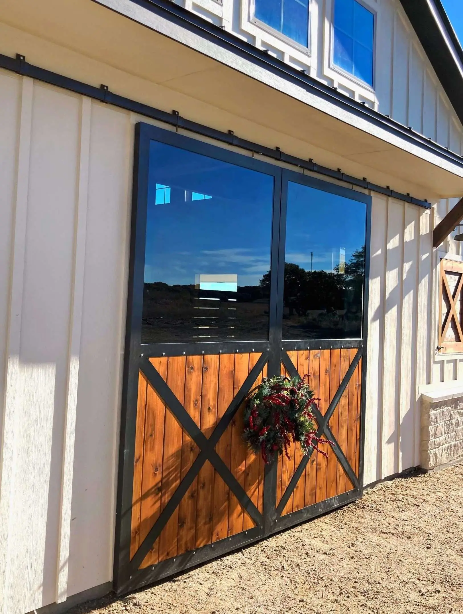 Barn with black steel-framed windows and a sliding door.
