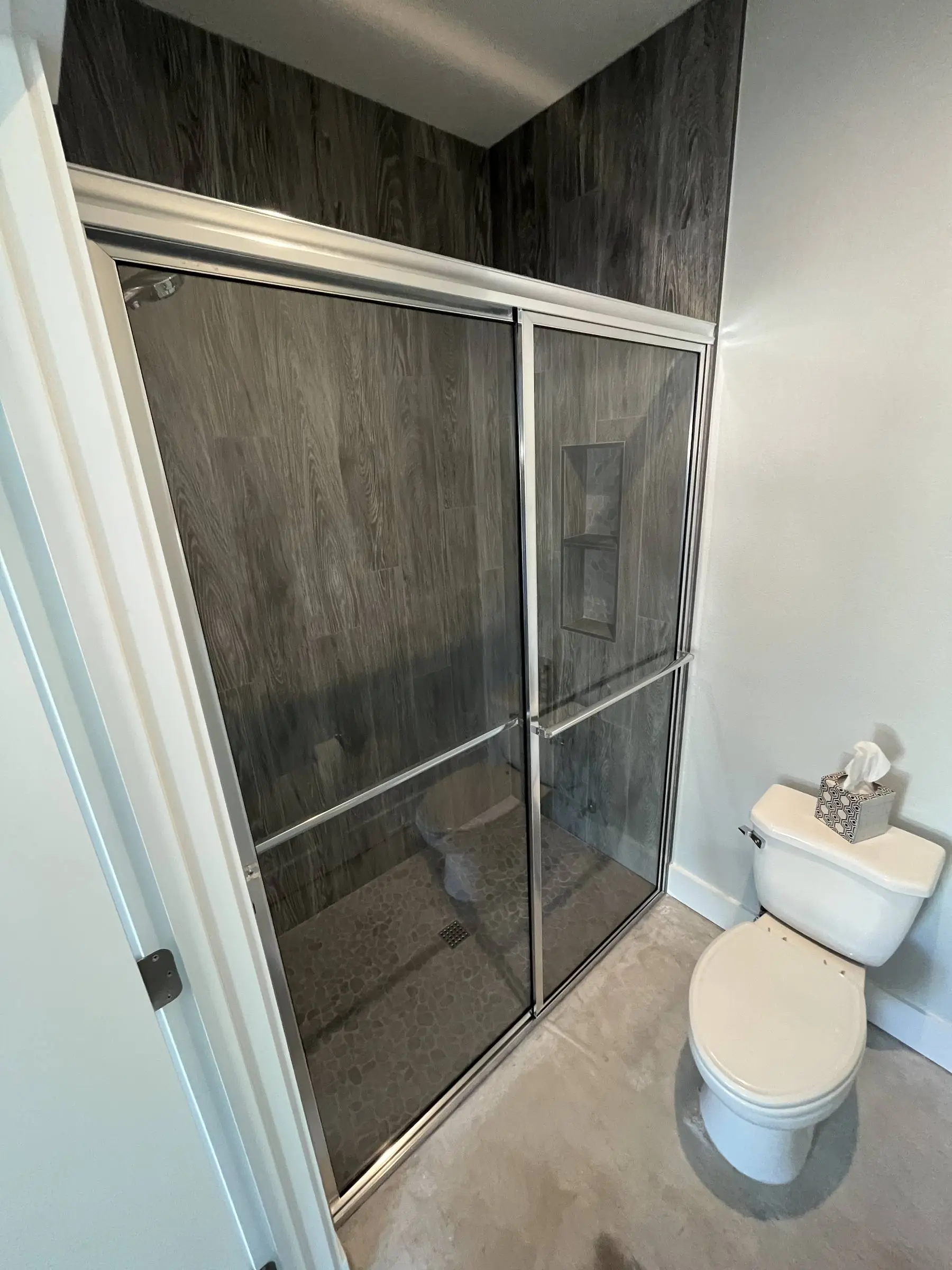 Bronze-framed bypass shower doors.