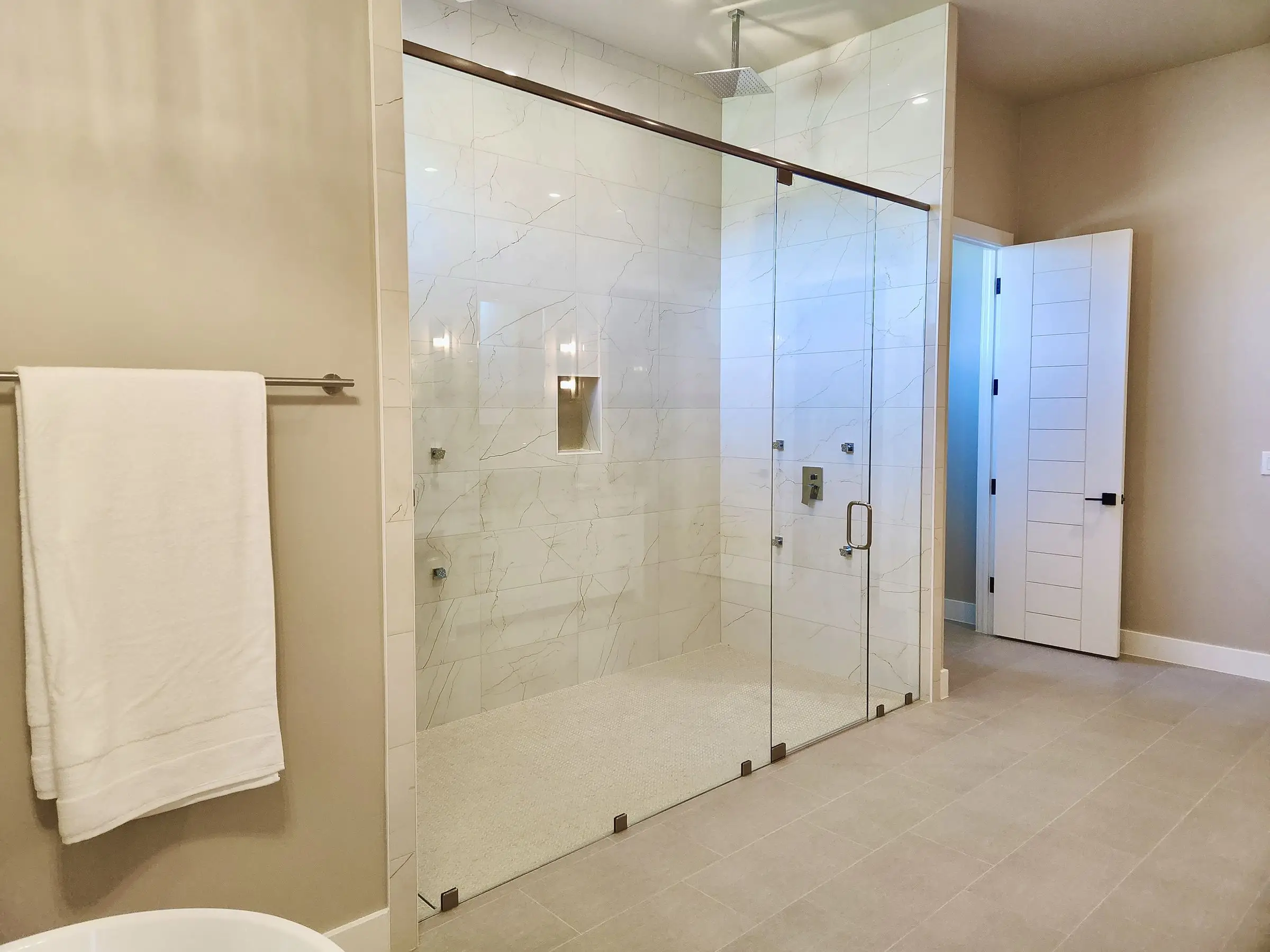 Frameless glass double shower doors.