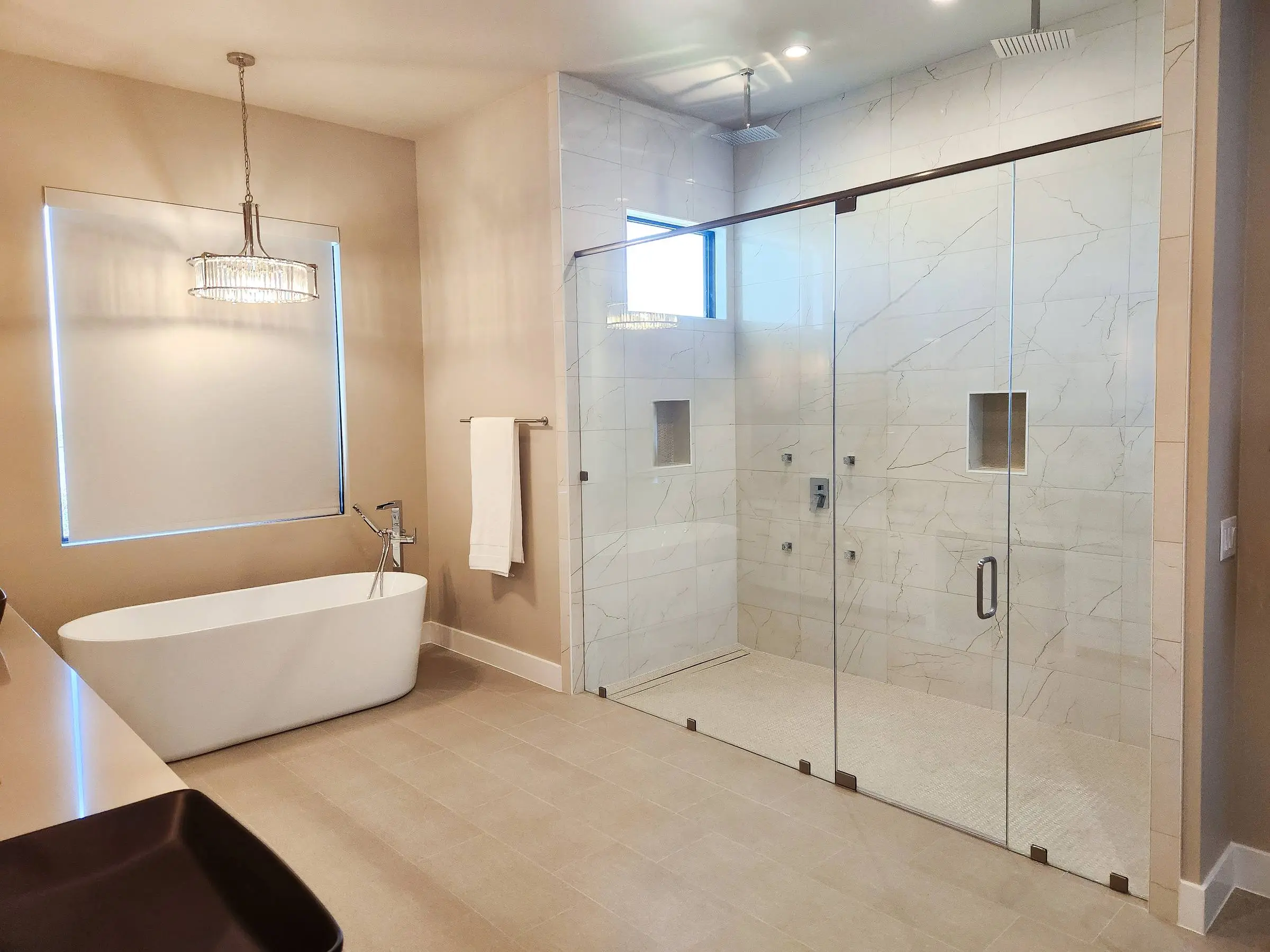 Frameless glass shower with double swing doors installed by Marble Falls Glass.