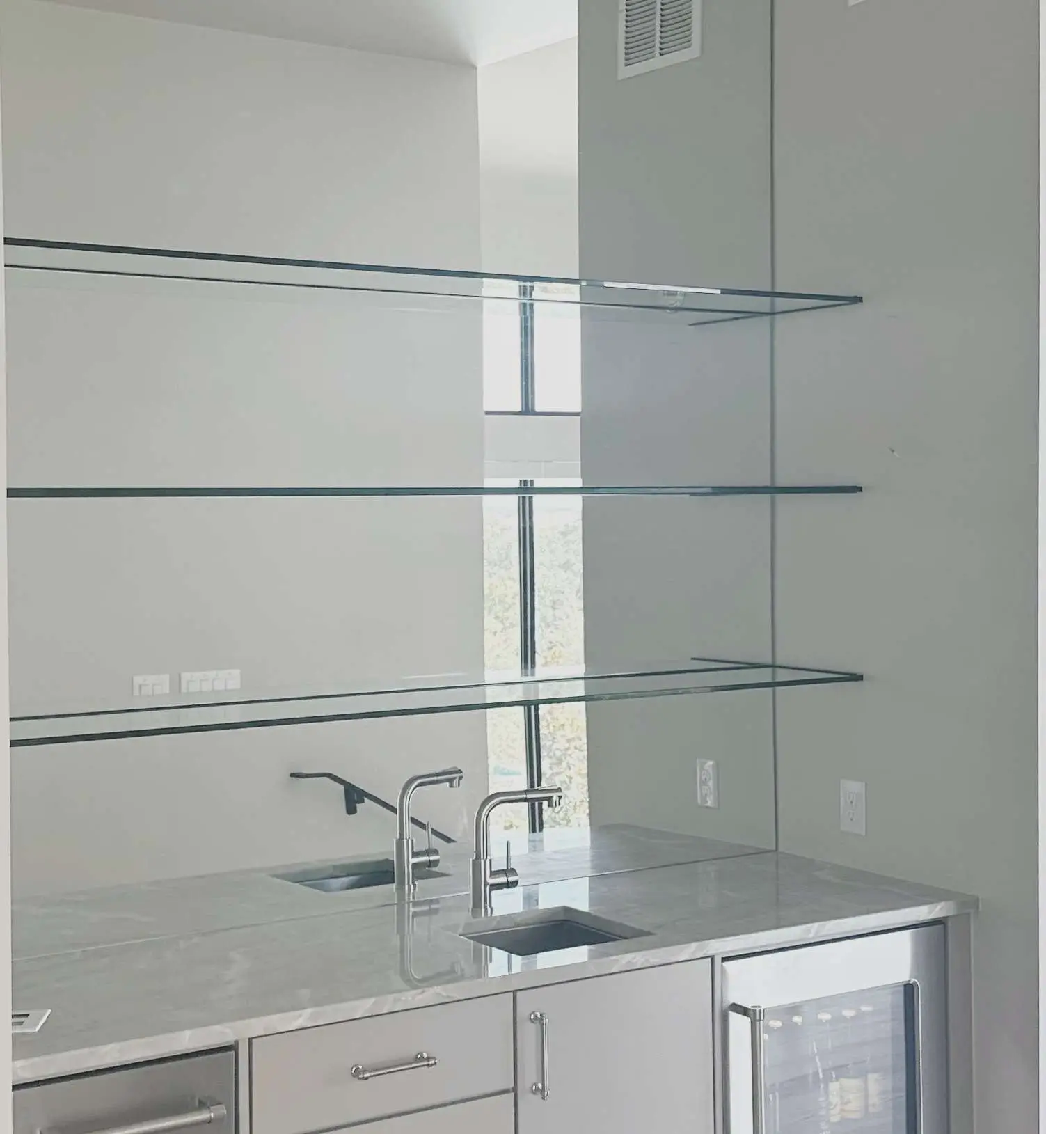 Glass shelving above a vanity in a Central Texas home.