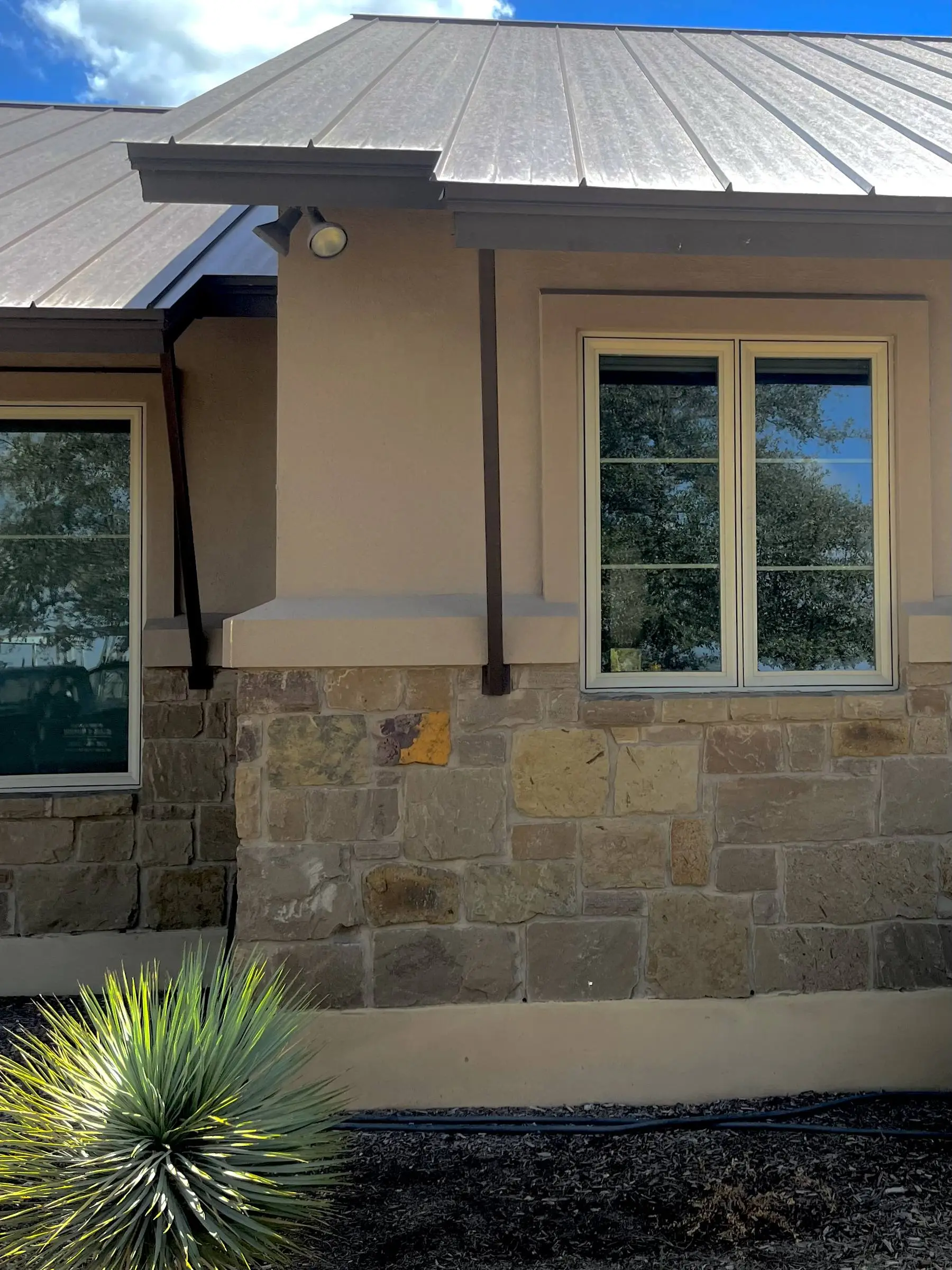 Stone-wall home exterior with a wood-trimmed window.