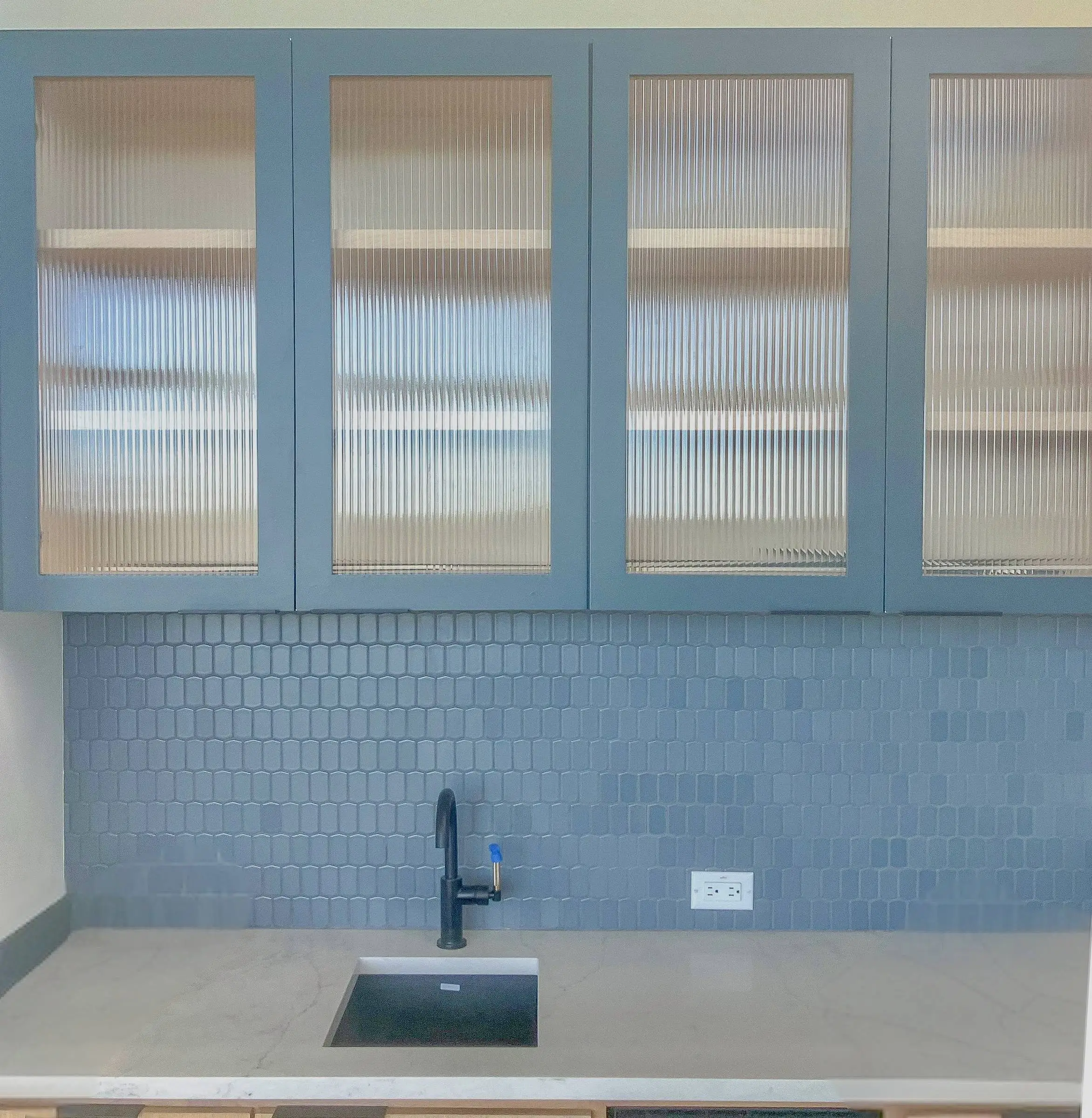 Wet bar with a glass-front upper cabinet.